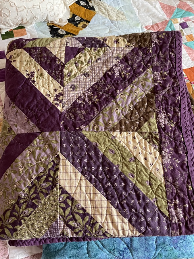 Purple and green star quilt with deep purple and sage green floral fabrics